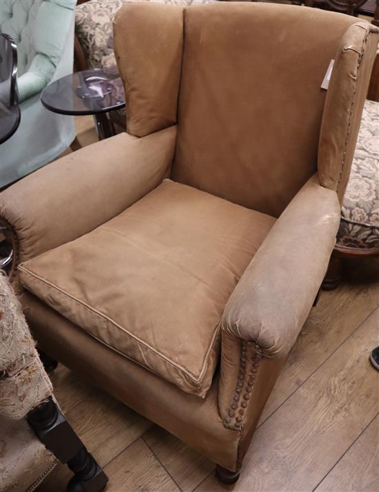 A late Victorian studded upholstered wing armchair